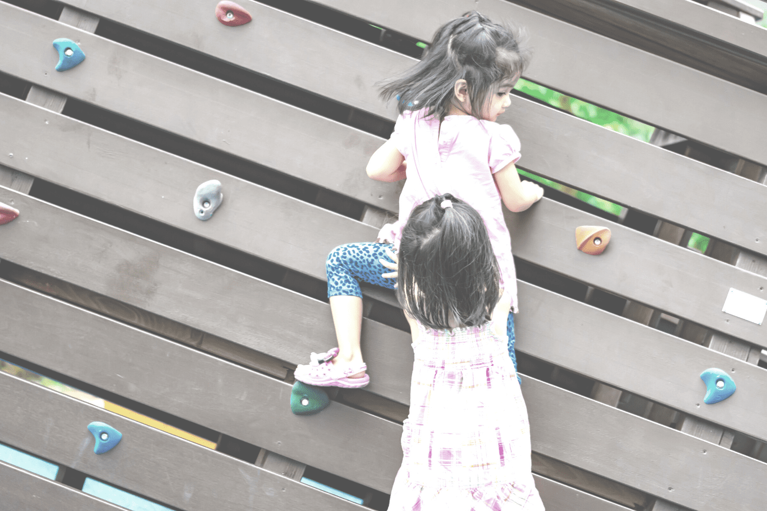 children showing resilience climbing on wall with rocks