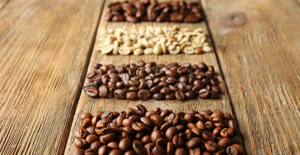 different coffee beans on wooden background
