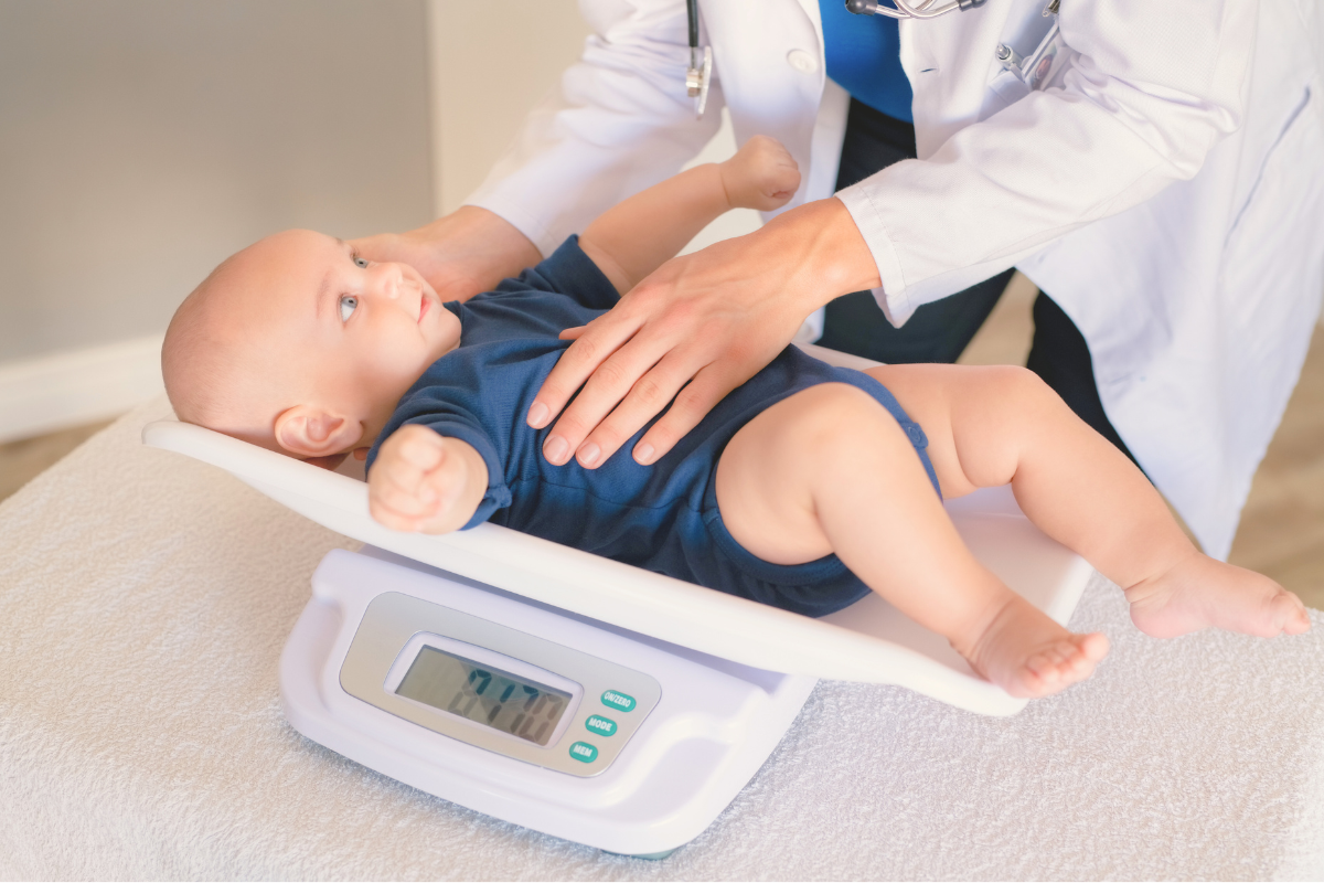 Infant being weighed. Poppyseed Play