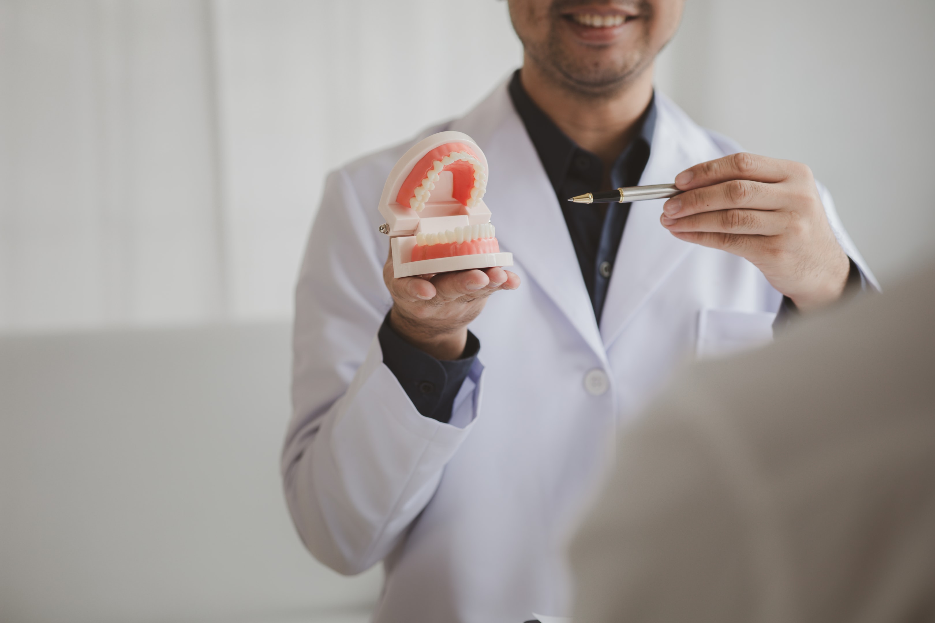 oral and maxillofacial surgeons explaining how jaw surgery can help to better align upper and lower teeth