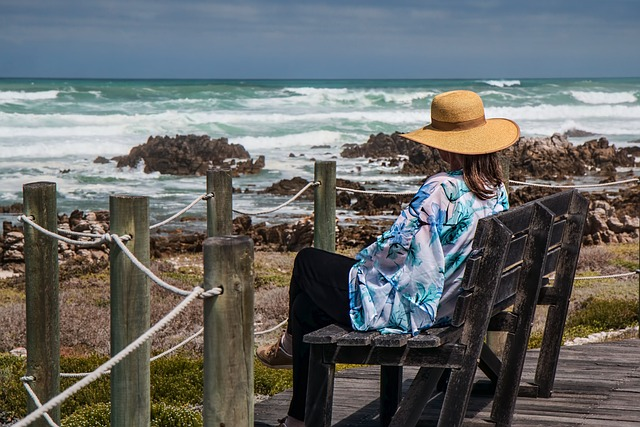 woman sitting in chair near beach
