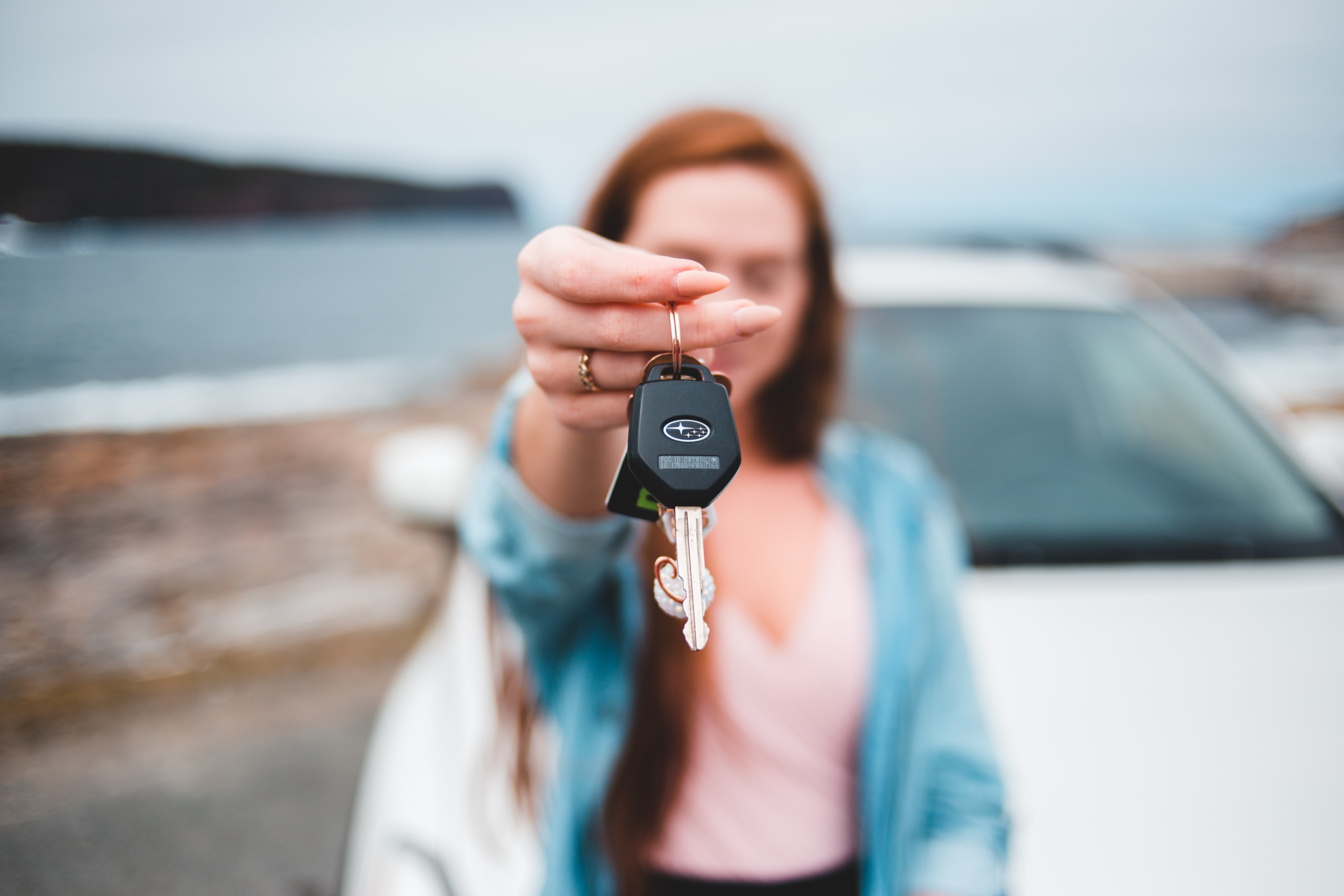 woman holding out her car keys