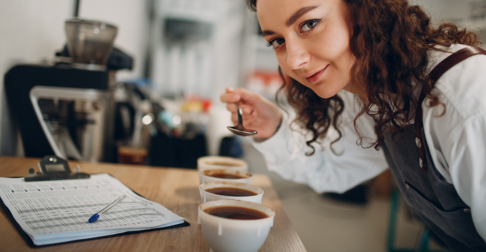 woman testing and recording coffee tastes