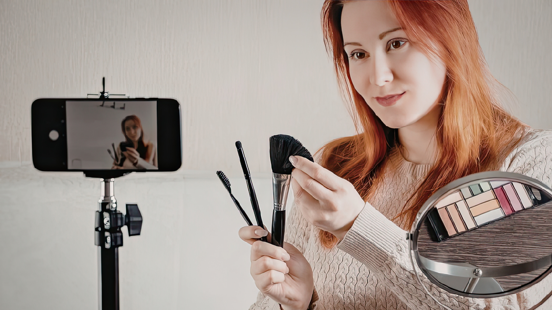 Influencer filming live stream shopping content with makeup brushes