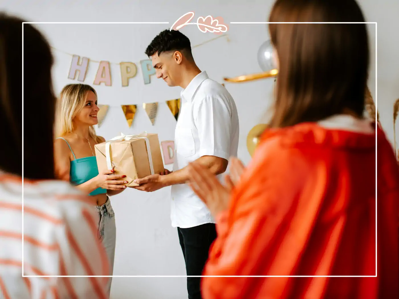 Man giving a wrapped gift to a woman at a party - fabulous flowers and gifts