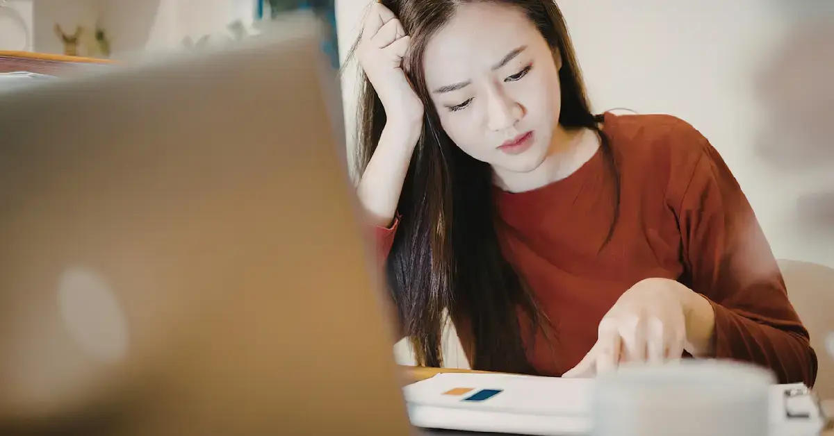 Woman reviewing finances and confused about unreported income from multiple platforms.