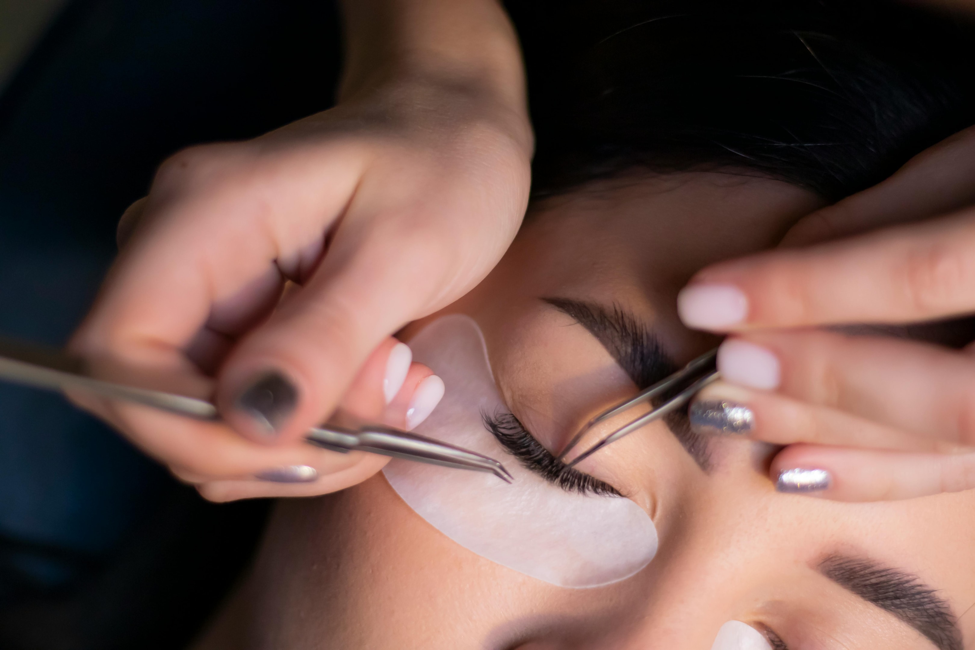 Closeup of a professional doing a lash lift on a client