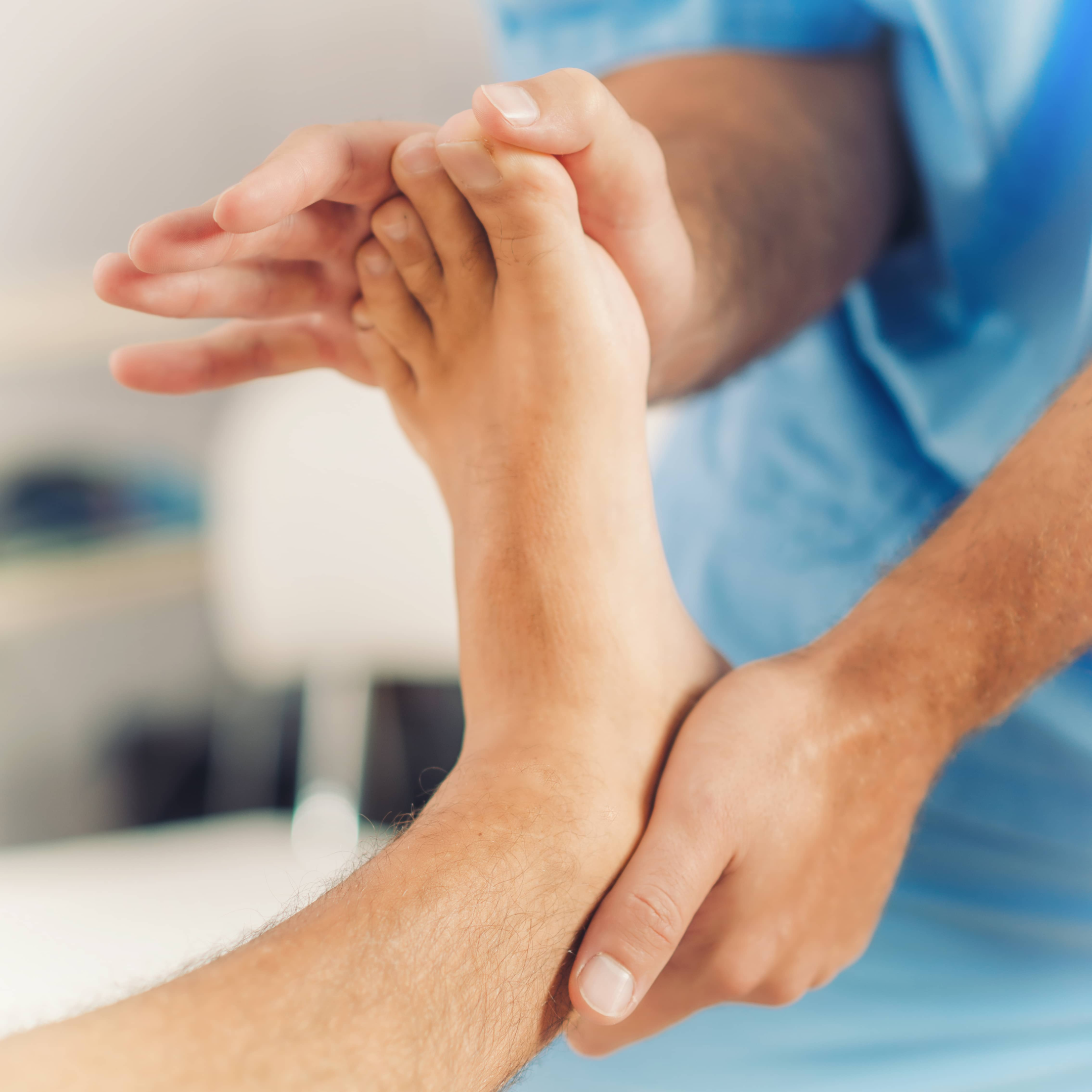 chiropractor stretching the extensor tendons with hand on top of the foot, for tendonitis  Main symptom is pain from tendinitis, so plantar flexion is avoided during treatment.