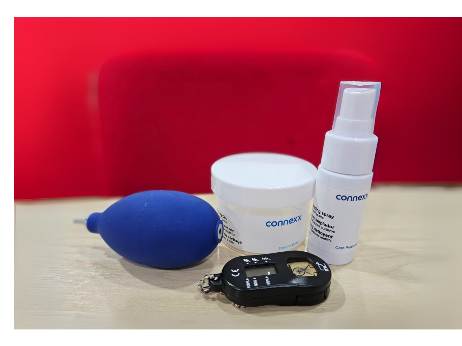 Hearing aid care and maintenance kit including cleaning spray, drying tools, and care accessories used to support reliable hearing aid performance and proactive aftercare