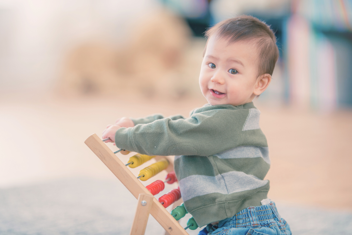 A toddler playing with a wooden toy