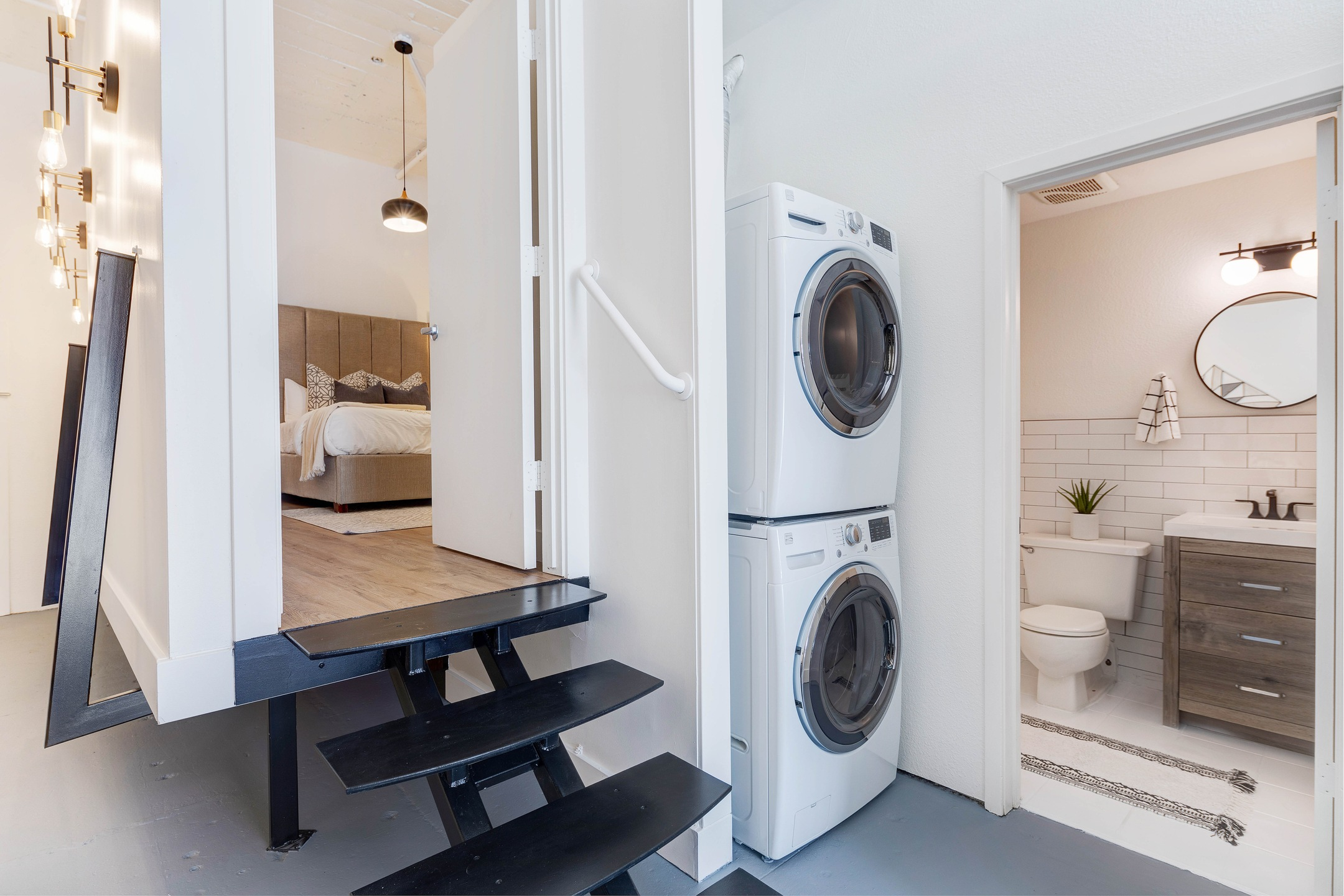 Both a washer and dryer stacked in an apartment providing more storage space