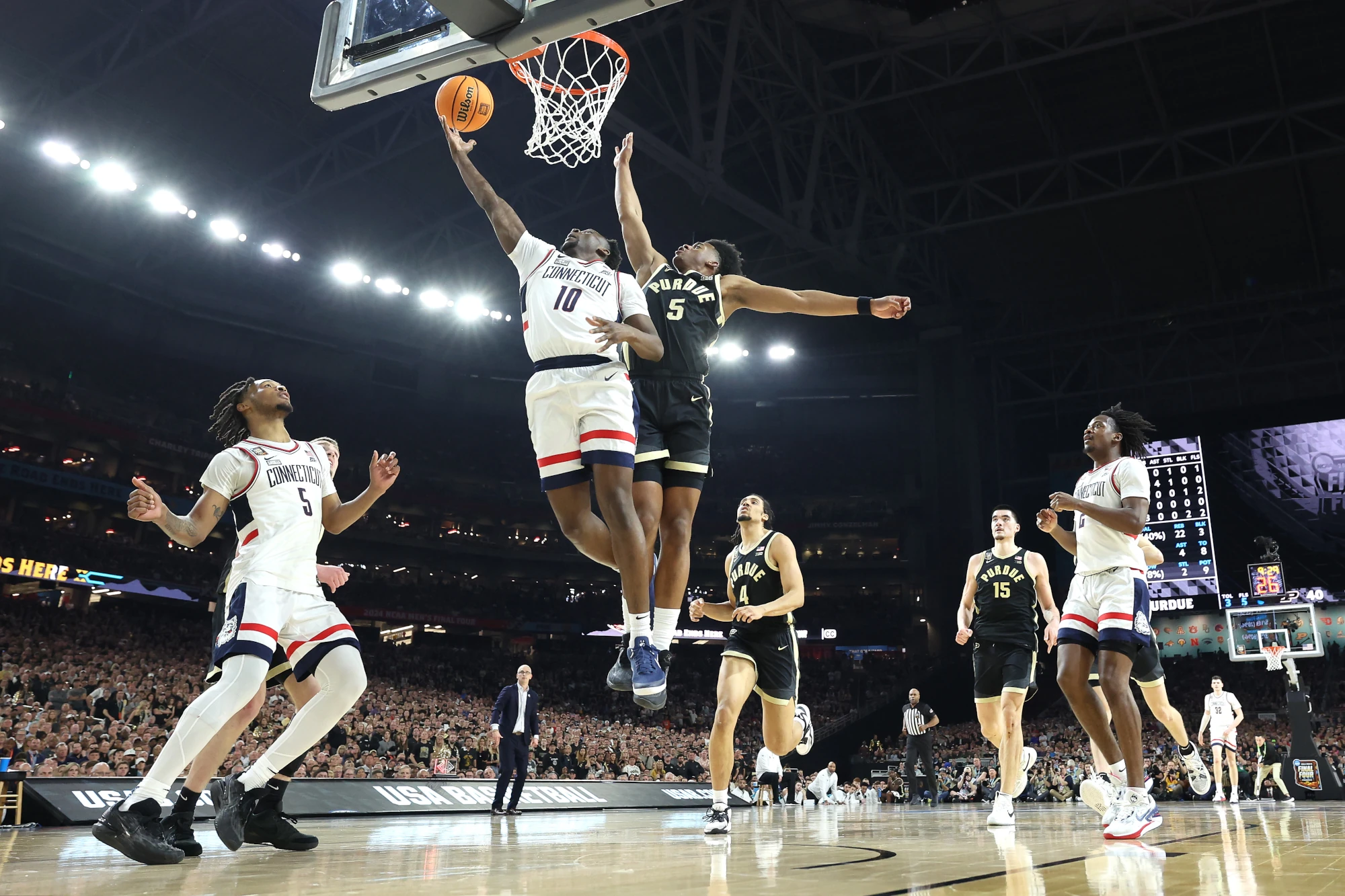 Hassan Diarra #10 of the Connecticut Huskies attempts a layup while being guarded by Myles Colvin #5 of the Purdue Boilermakers in the second half during the NCAA Men's Basketball Tournament National Championship game at State Farm Stadium on April 08, 2024 in Glendale, Arizona. 