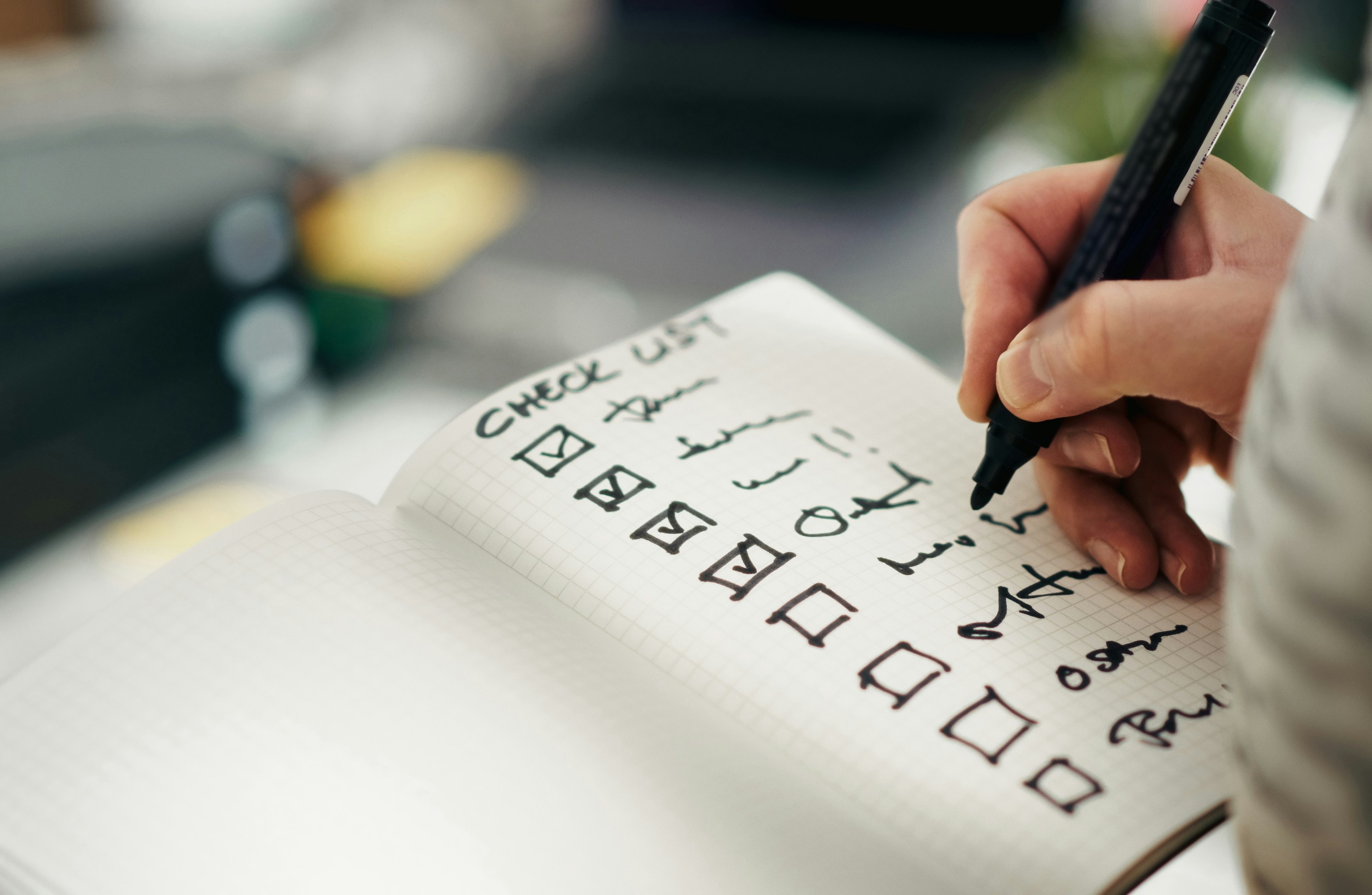 Real estate investor writes checklist for flipping houses.
