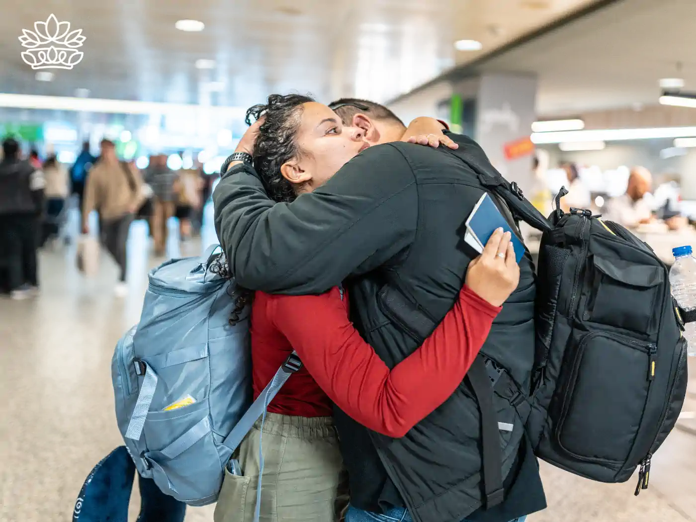 A couple embracing in an airport, expressing heartfelt joy and reunion - Fabulous Flowers and Gifts, Heartfelt Moments Collection