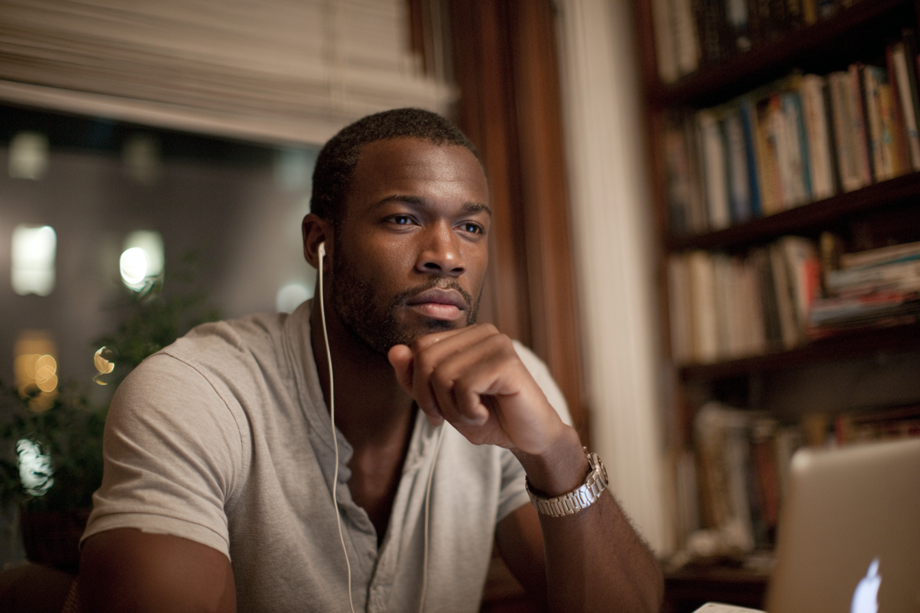 Online men's group therapy in New York: a participant listens during a secure video session led by Paul Chiariello, LMSW