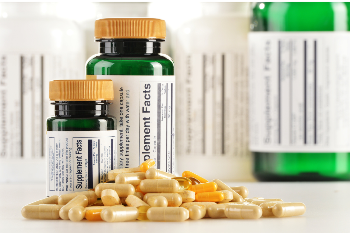 Labeled dietary supplement bottles with capsules displayed for product quality control