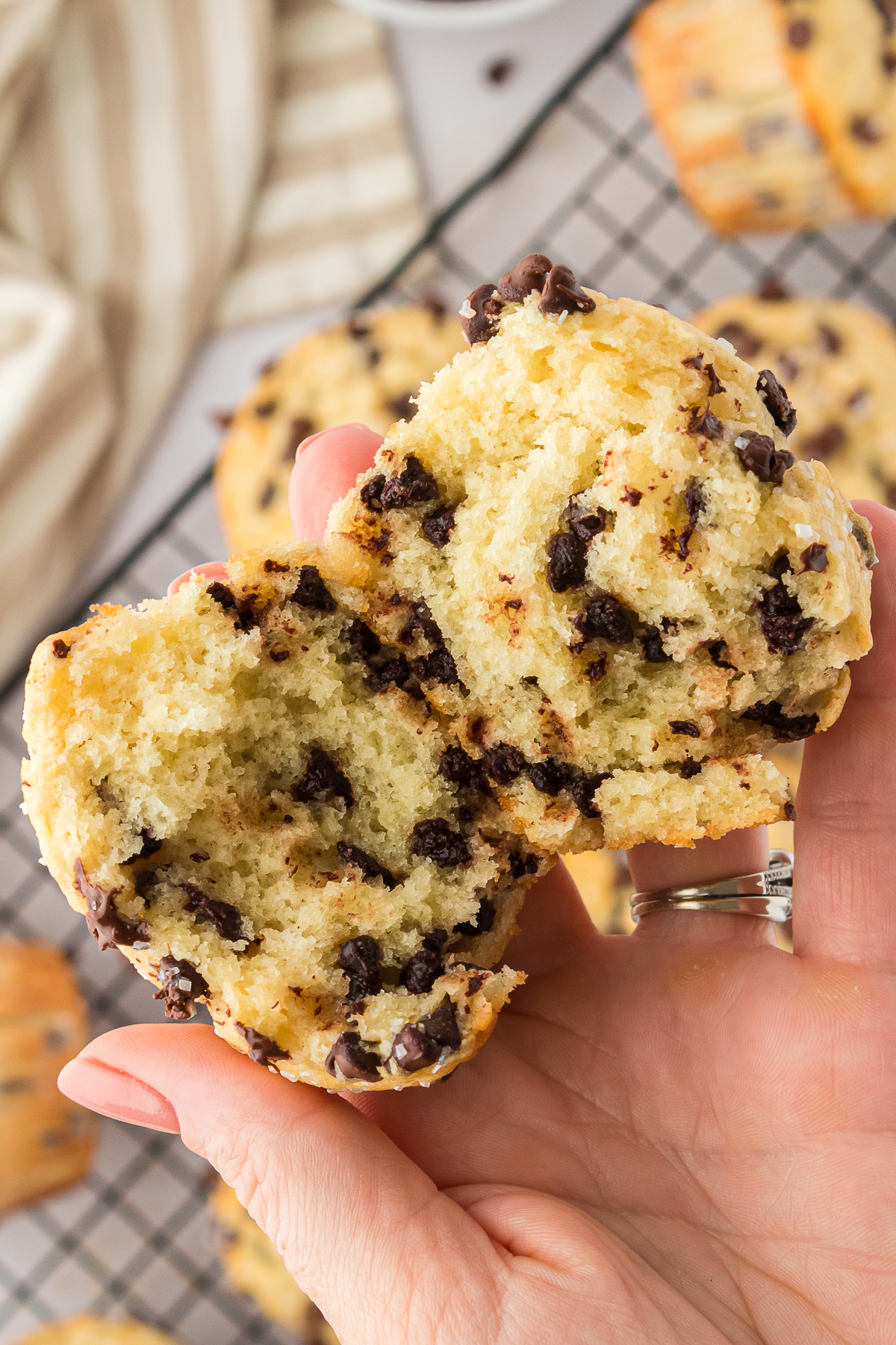 hand pulling open a chocolate chip muffin