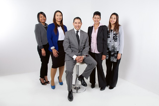 How Minority Temporary Staffing Solutions Can Optimize Your Business Operations 7 five minority corporate workers with four female and one male standing in group