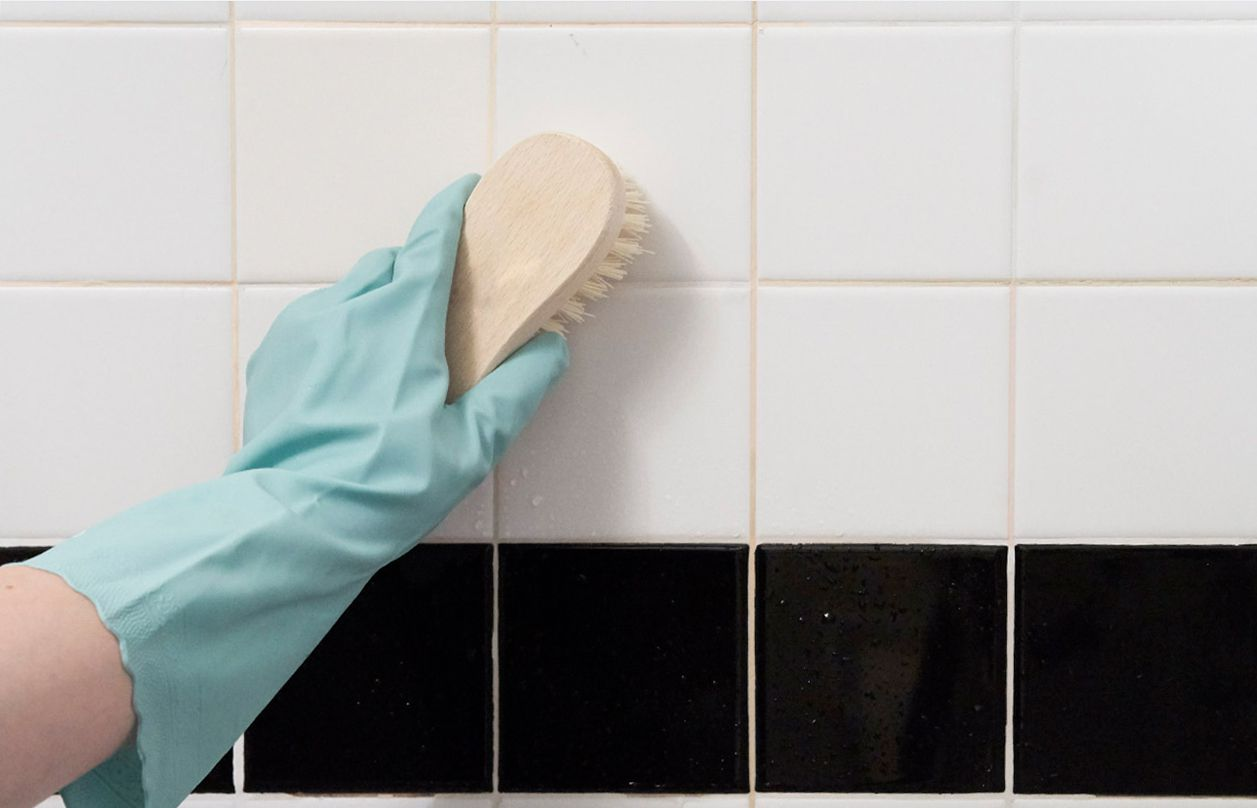 Scrub and rinse the shower wall with sponge