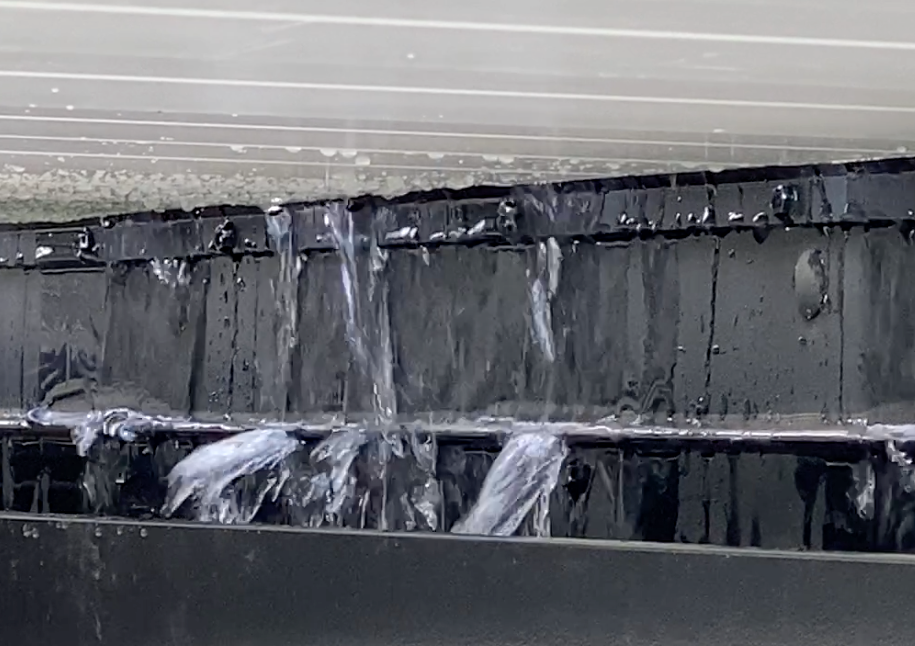 water running in integrated gutter system in aluminum roof