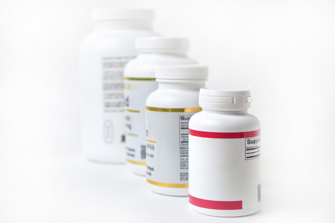 A lineup of supplement bottles representing label compliance and manufacturer certification checks