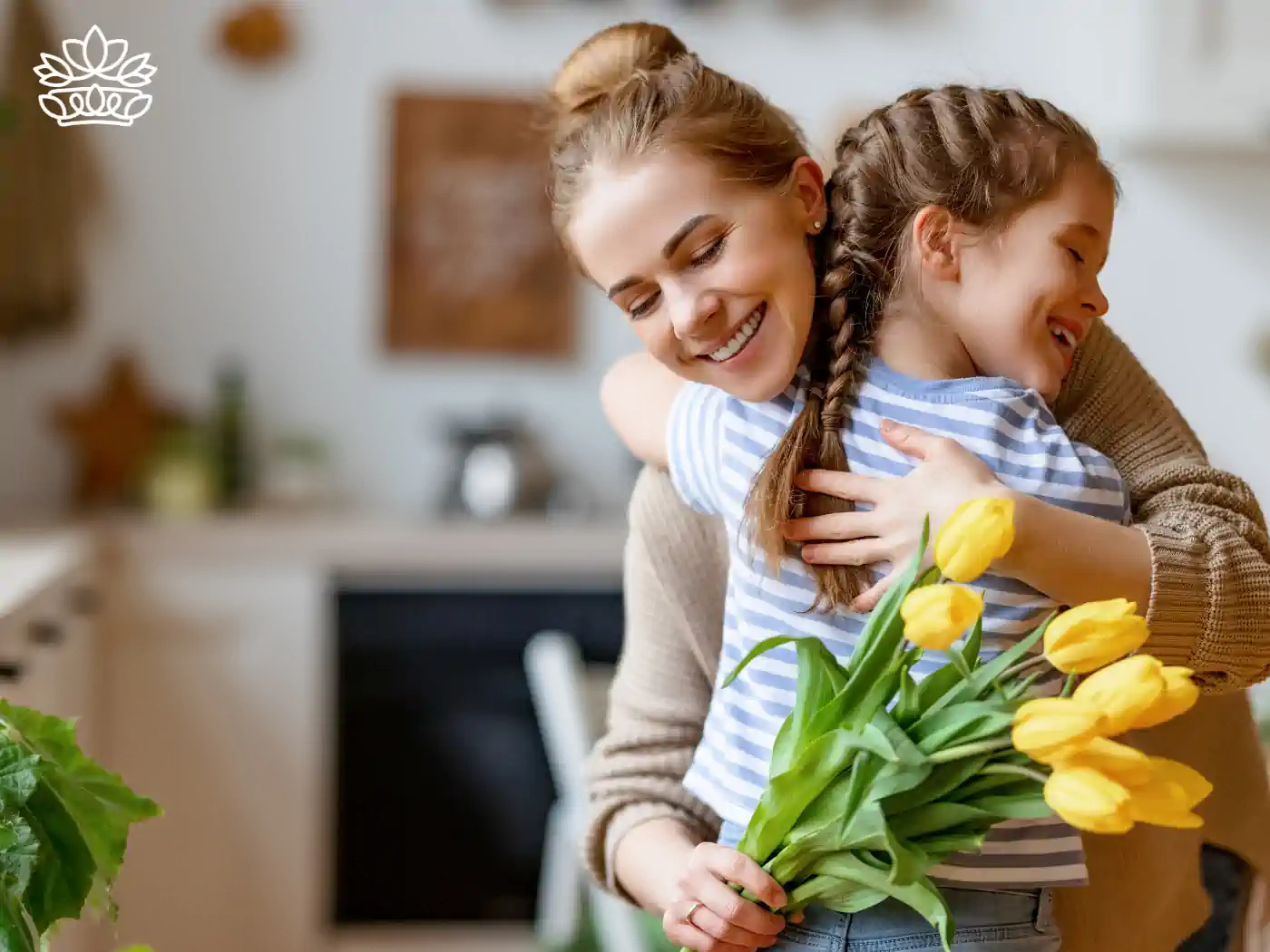 A mother and daughter sharing a joyful hug, the daughter holding a bouquet of yellow tulips. Gemini Flowers & Gifts Collection. Fabulous Flowers and Gifts.