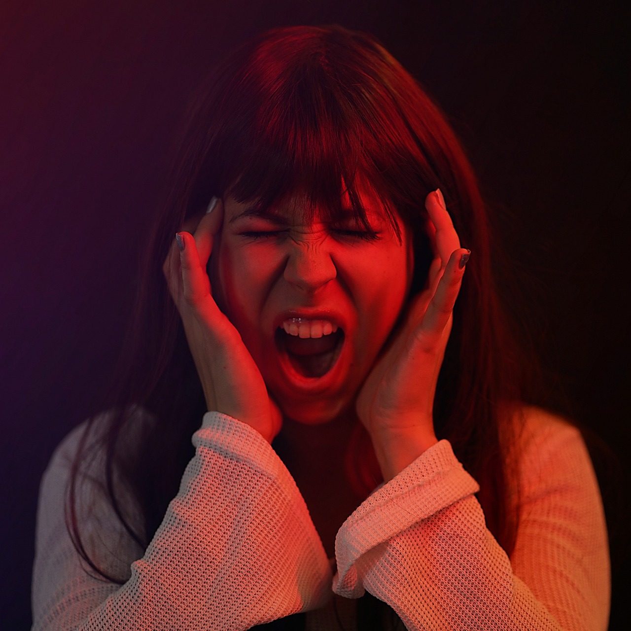 An image of a woman not practicing vocal cord care by screaming.