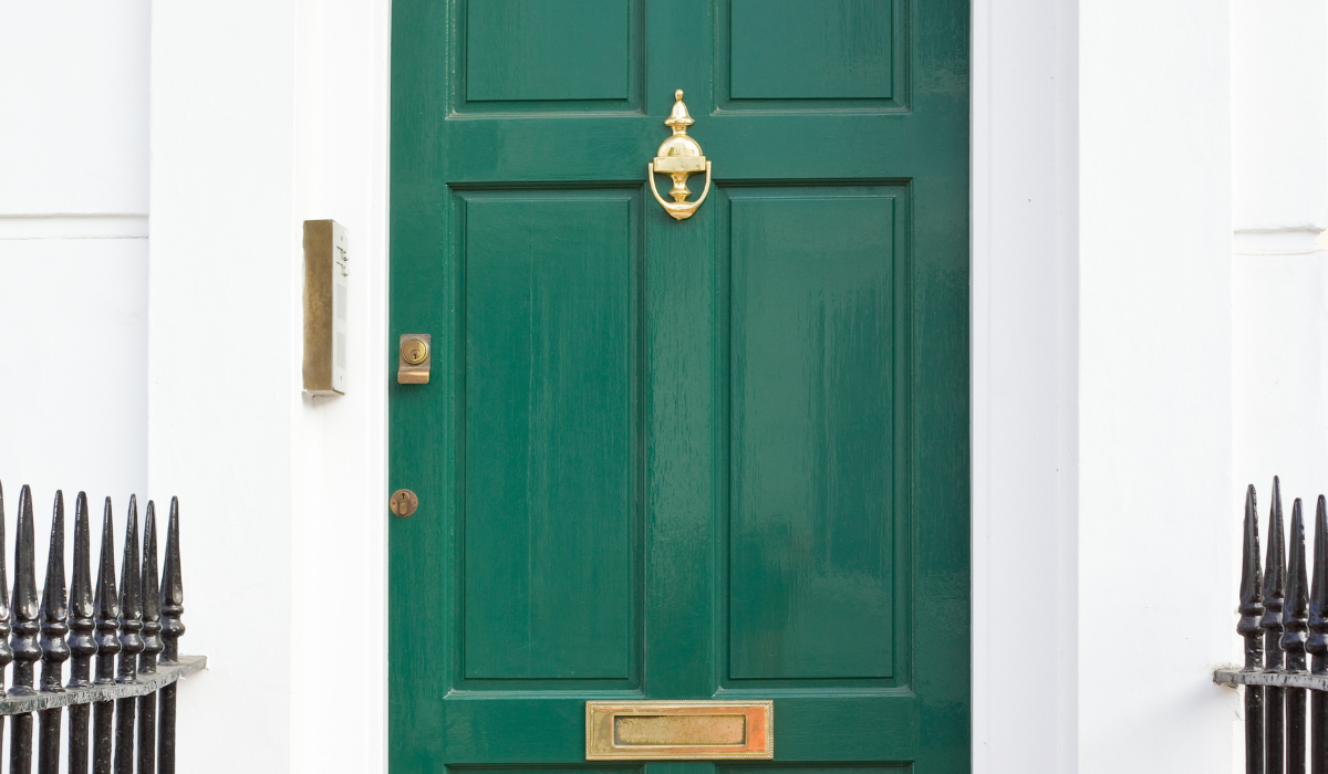 Traditional front door with brass urn door knocker 