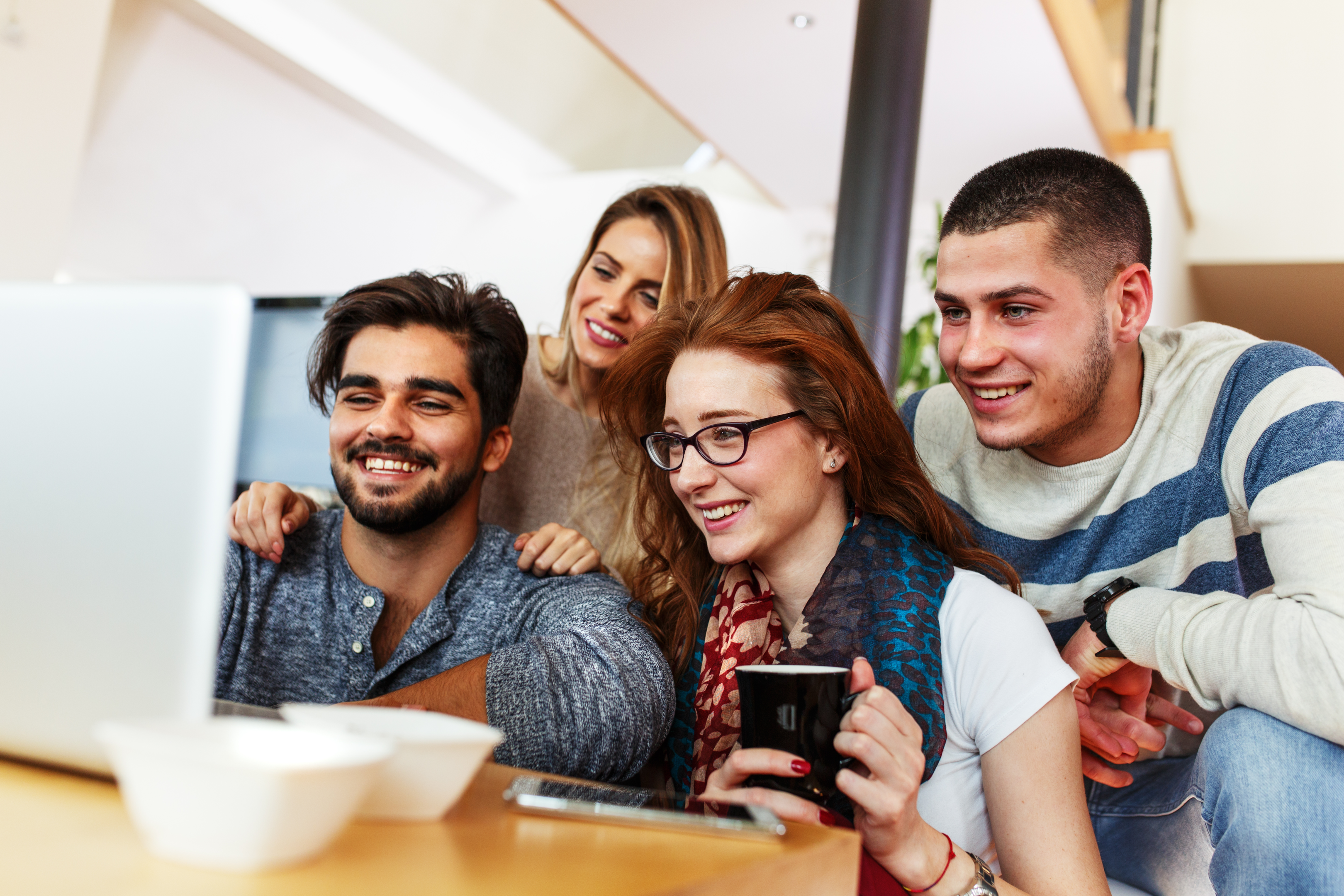 Group of people watching a video on a laptop