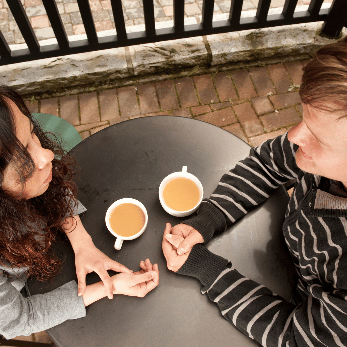 Couple talking over coffee: Featured In How Does A Virgo Man Test You