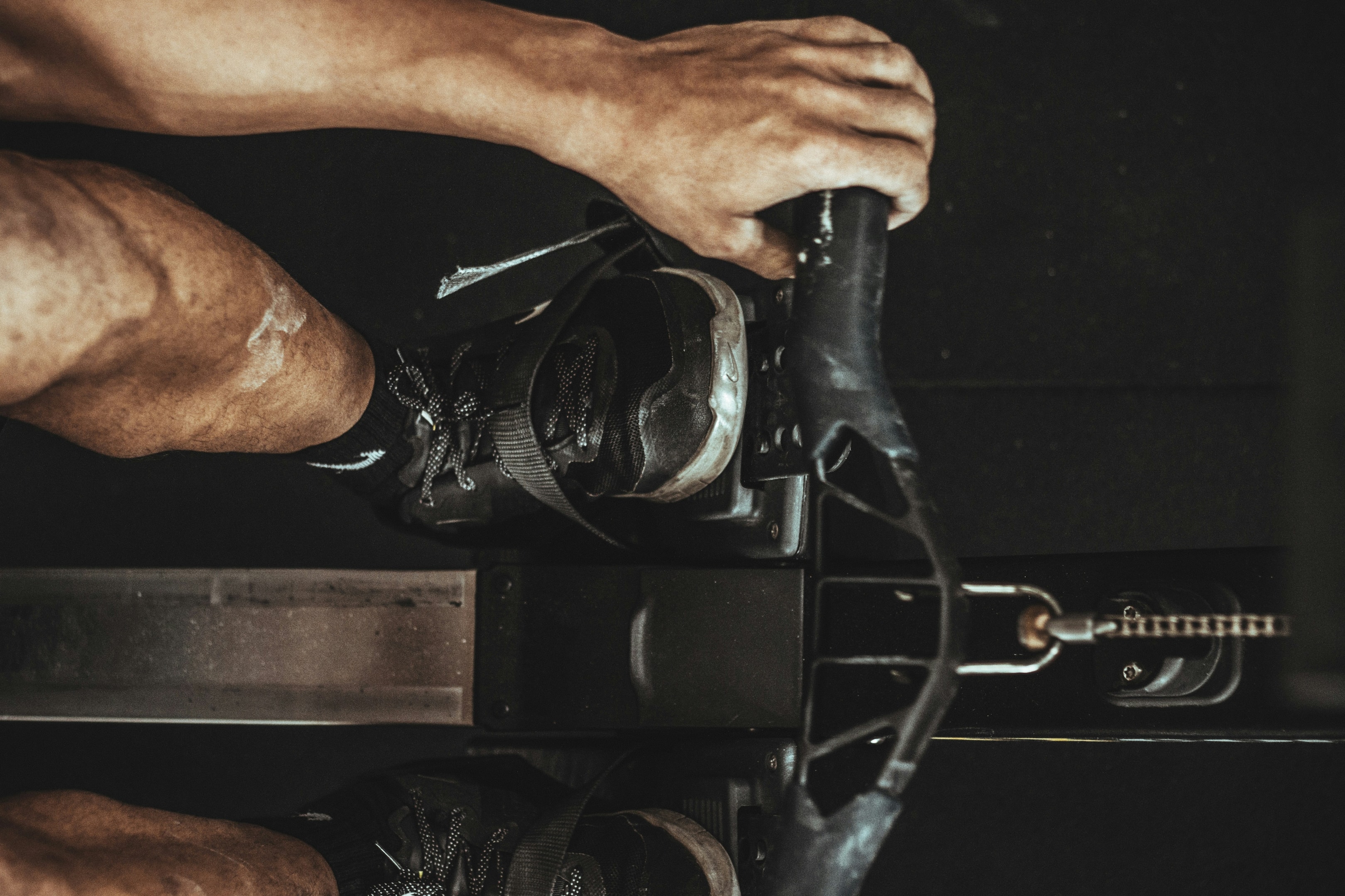 man rowing intensely on an indoor machine