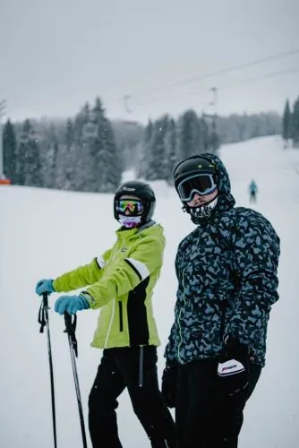 couple skiing with private or group lessons at one of the best places to visit in CT during winter vacation getaways