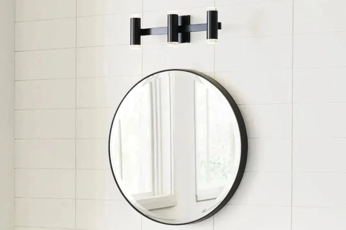 Dobson II 3-Light Bath fixture mounted above mirror, a stylish product that makes a clean design sign in any bathroom place.