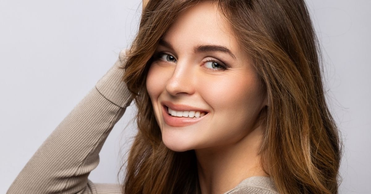 A brunette woman smiles brightly, reflecting a stress-free approach to learning how to pay excise tax.