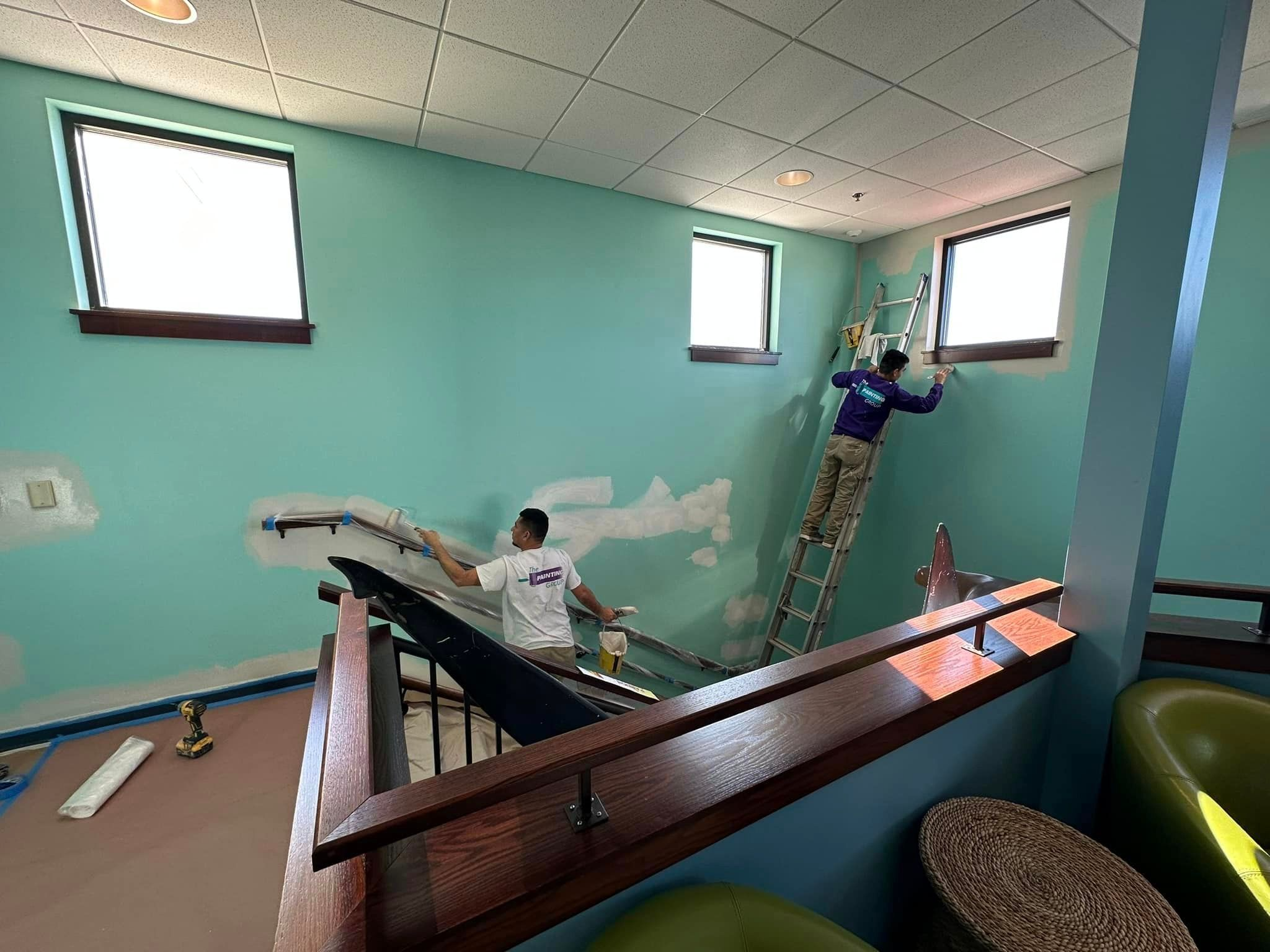painting contractors Lafayette IN working on interior walls