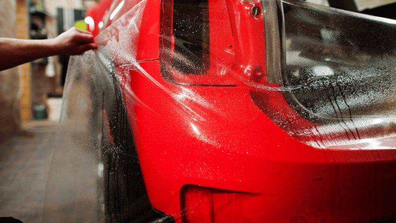 A man is wrapping PPF on the car.