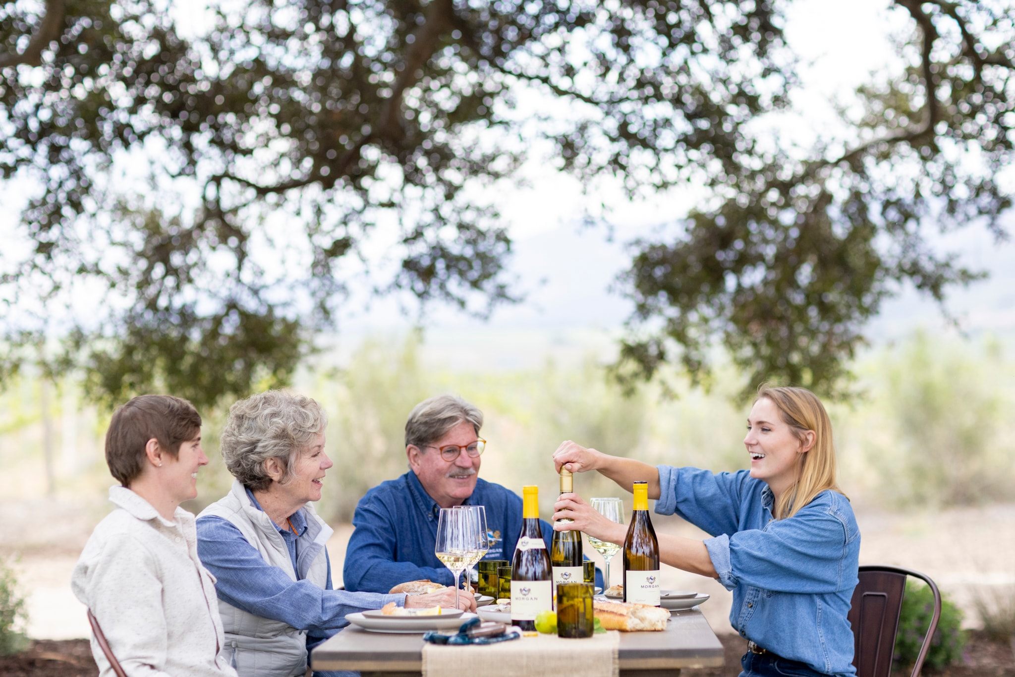 The Morgan family is outside enjoying food and their Chardonnay