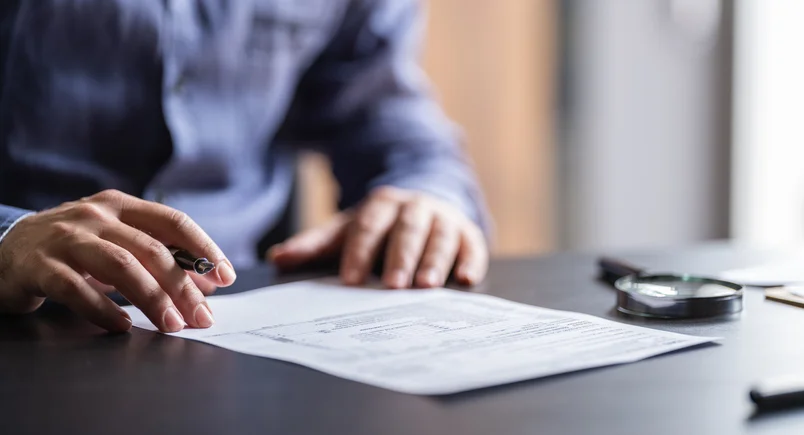 A person filling up a document