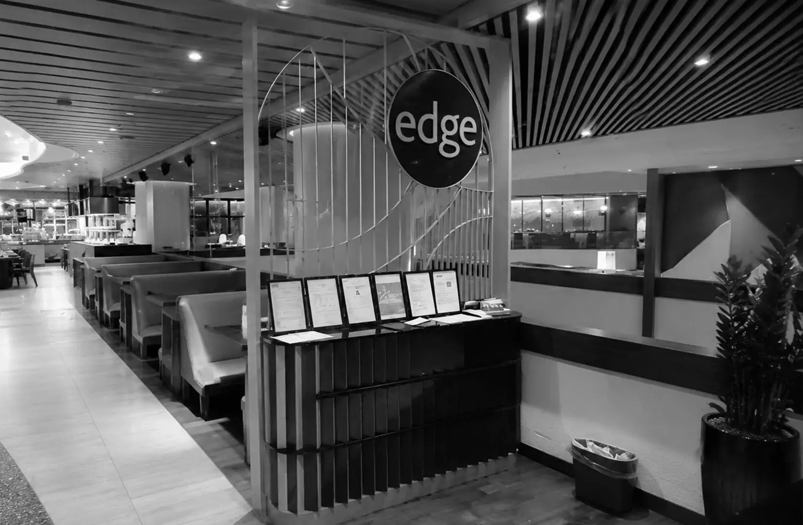 Edge Singapore buffet counter with a modern food station and dining area.