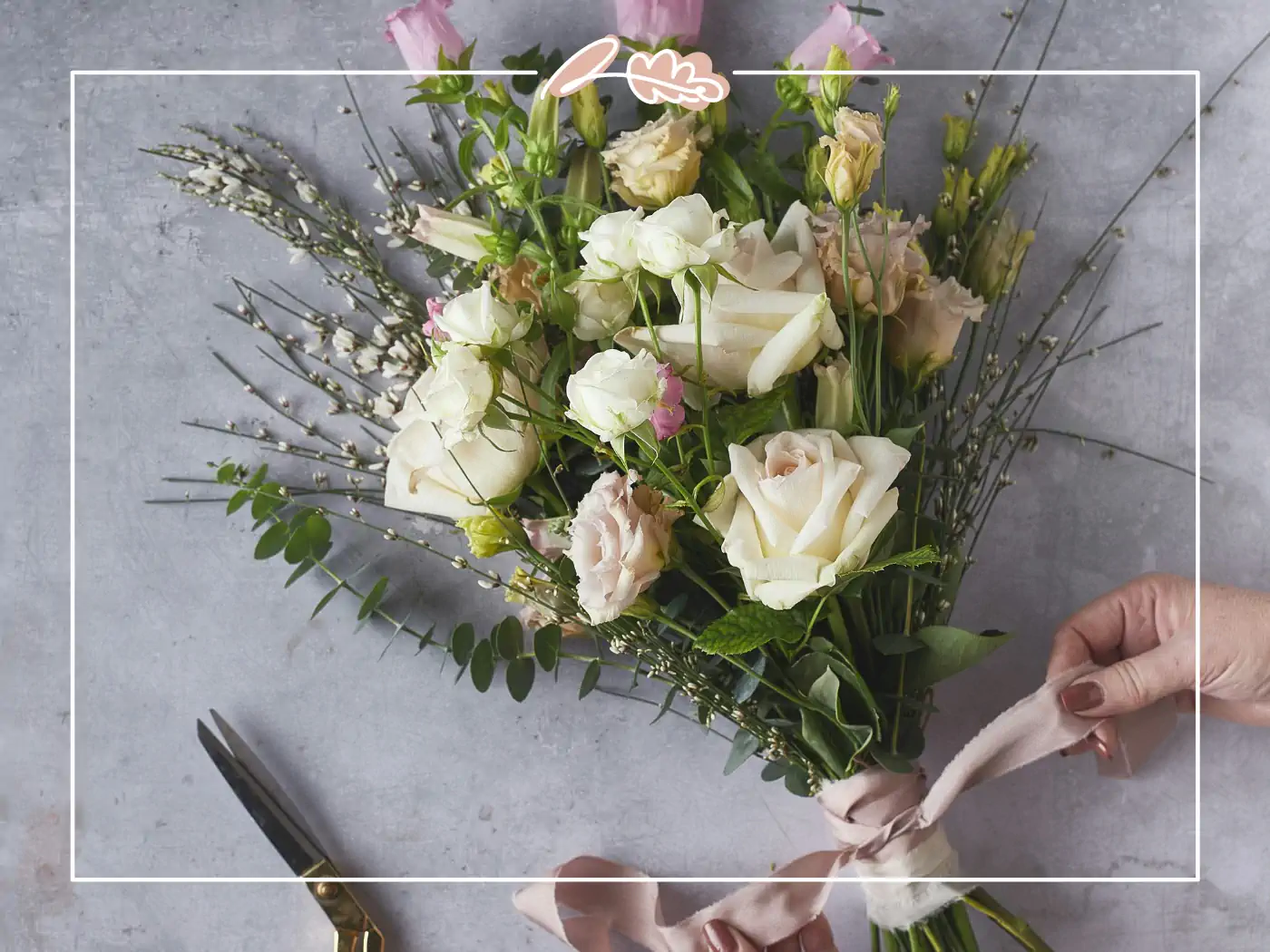 Hands tying a ribbon around a white and pink flower bouquet - Fabulous Flowers and Gifts