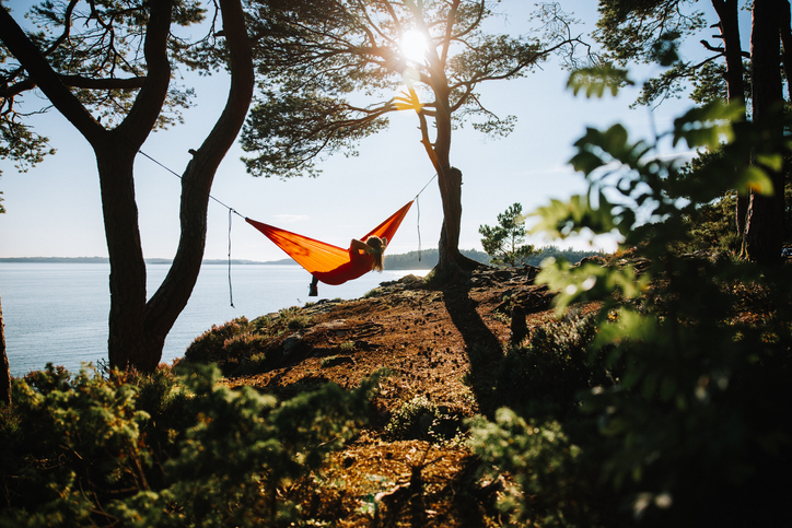 A camper relaxing in a hammock. 
