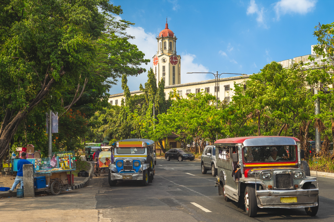 Jeepneys on a busy Manila street showing the higher cost of living in the capital region