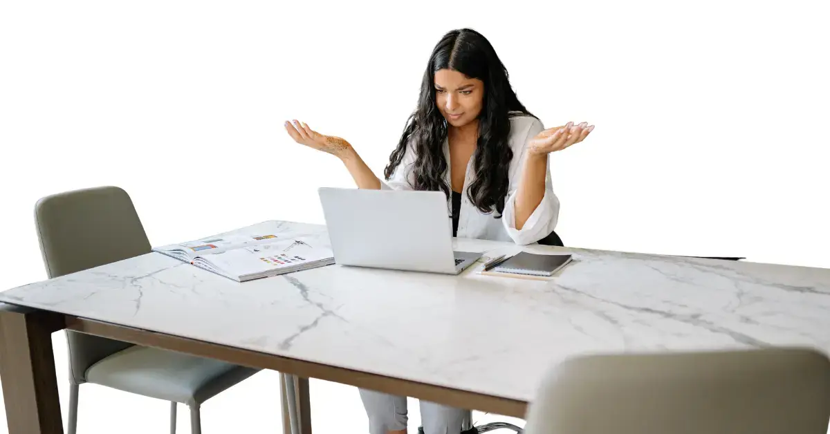 Woman learning how to calculate net income while reviewing earnings on a laptop.