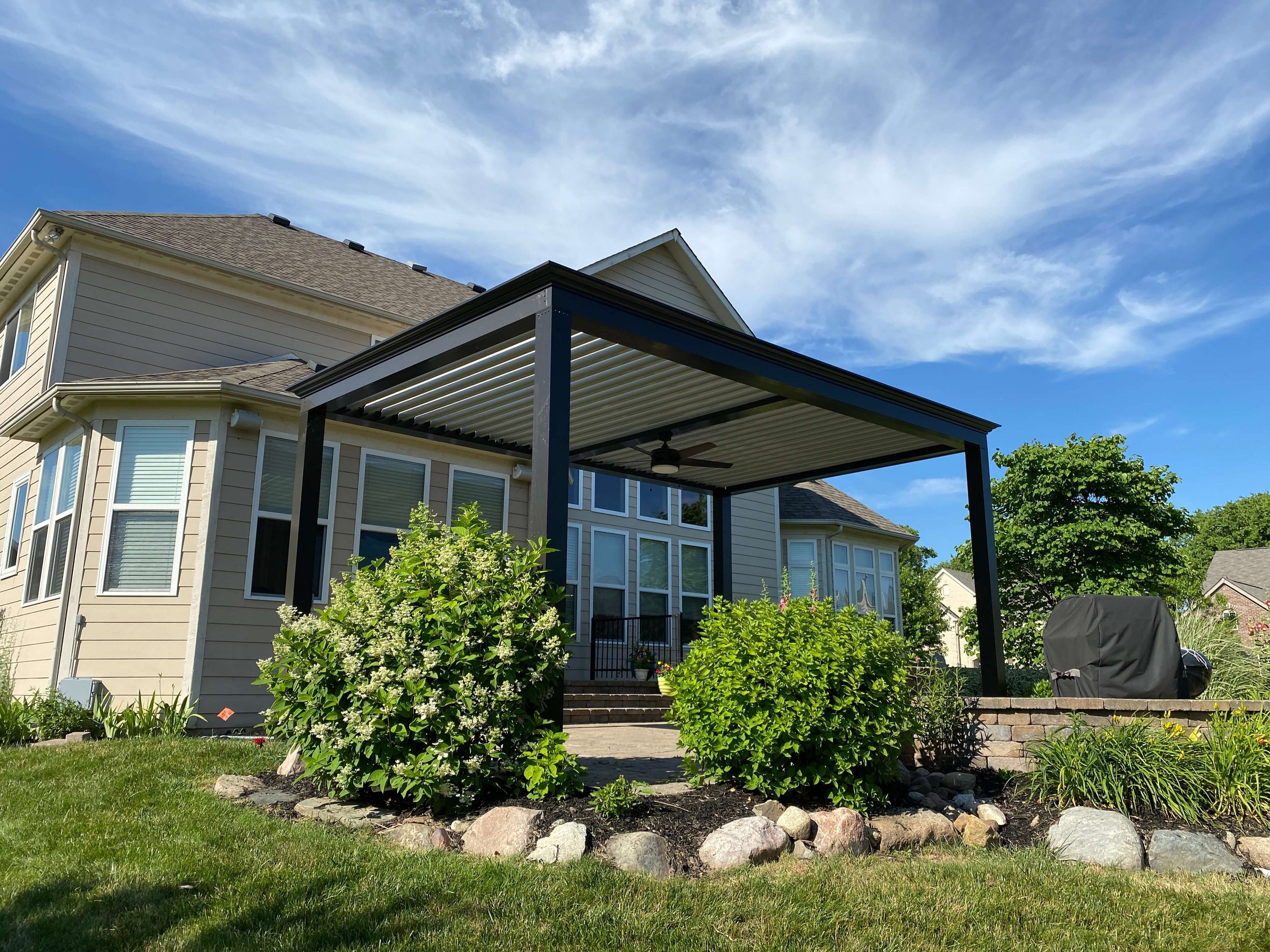 Beams And Post Of Pergola In Bronze With Stone Louvers Facing House