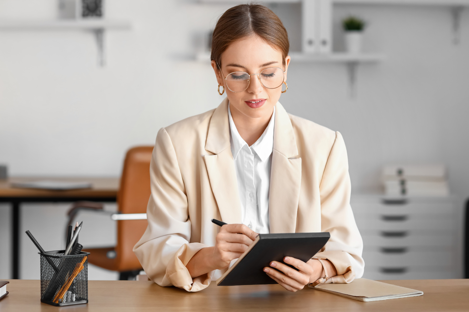 An HR manager writing open-ended interview questions.