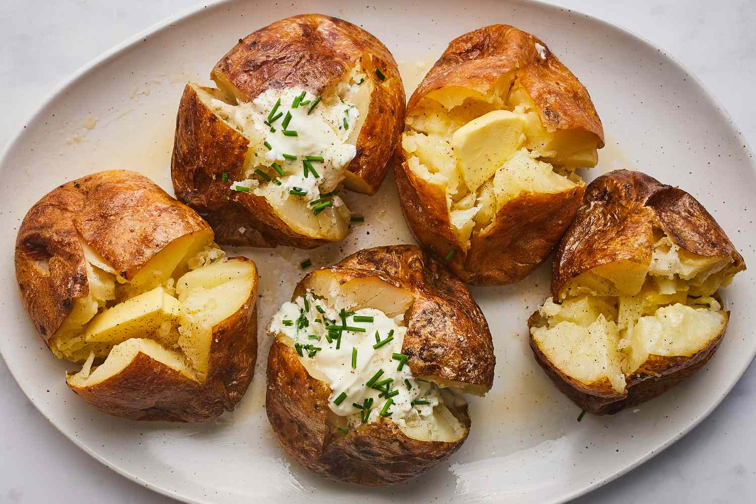Baked Potatoes Variety - Buttered and Topped with Sour Cream and Chives, Ideal Companions for Brisket