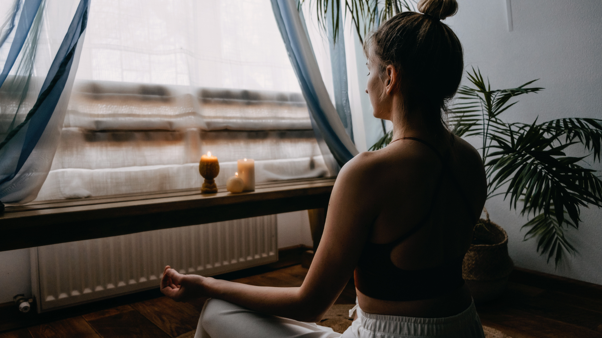 woman sitting on the floor meditating