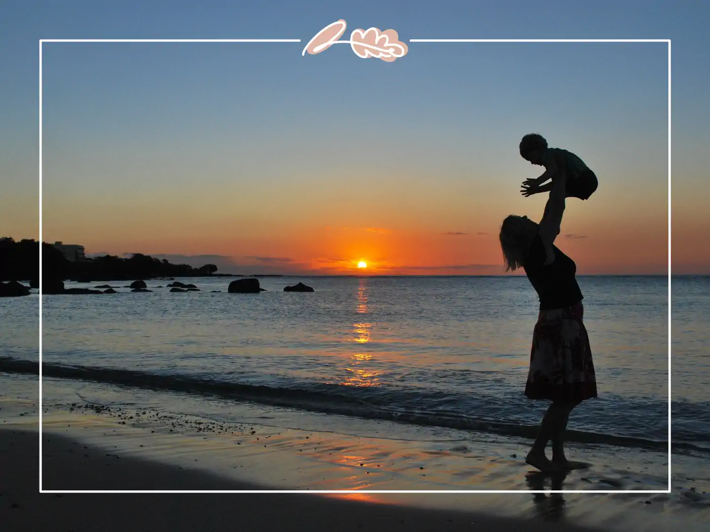 Mother lifting her child on the beach at sunset, fabulous flowers and gifts