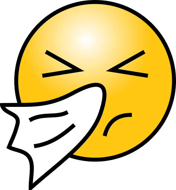 An image of an emoticon with a tissue to its nose due to the common cold. 