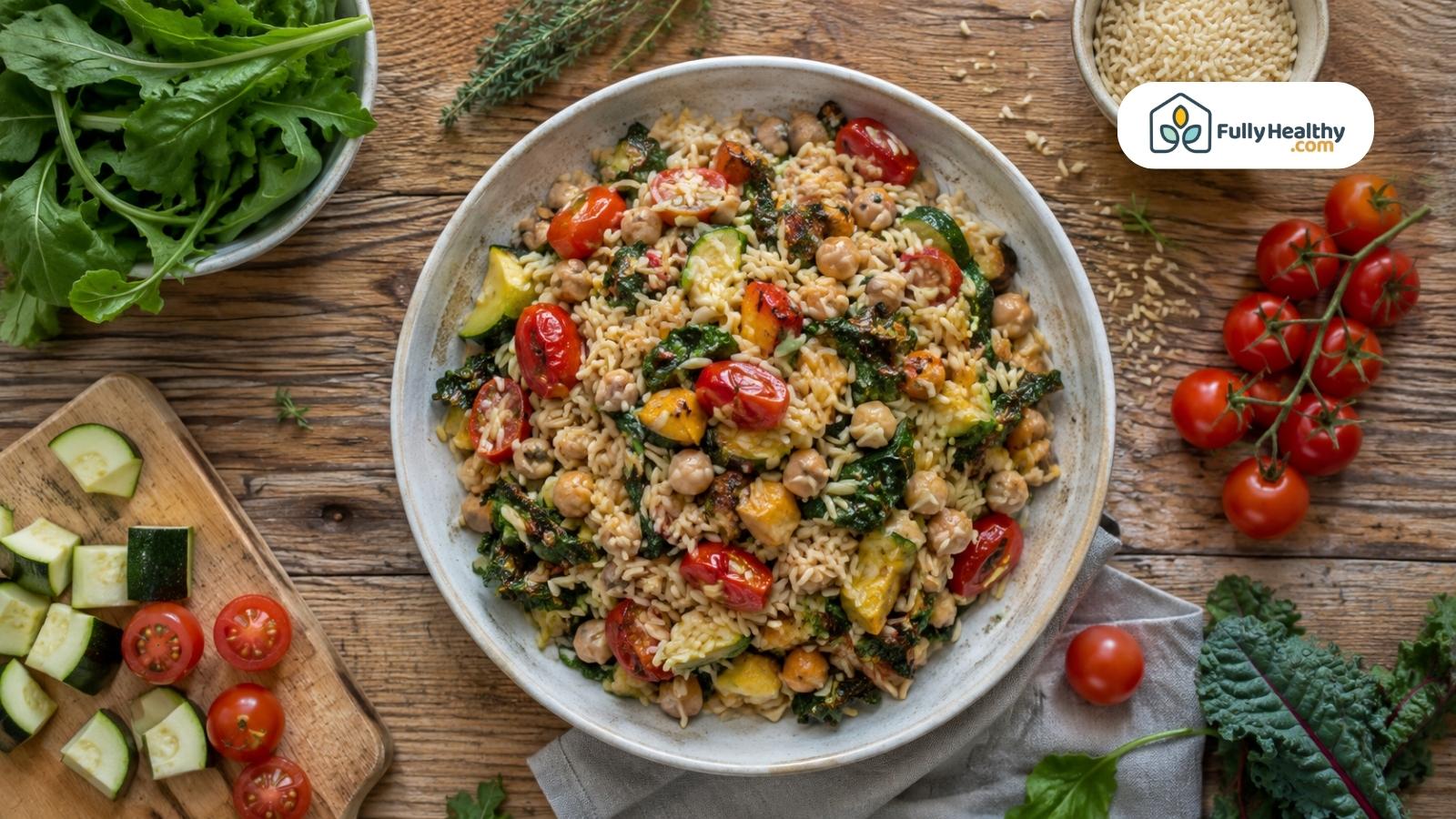 Orzo bowl with chickpeas roasted vegetables tomatoes and leafy greens